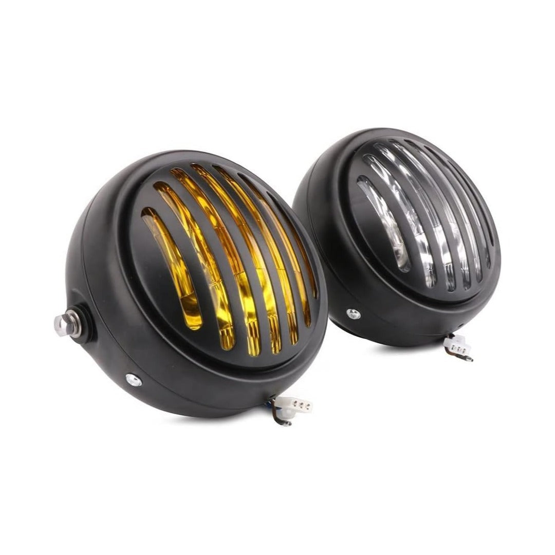 Pair of black round headlights with gold and clear grilles on a white background