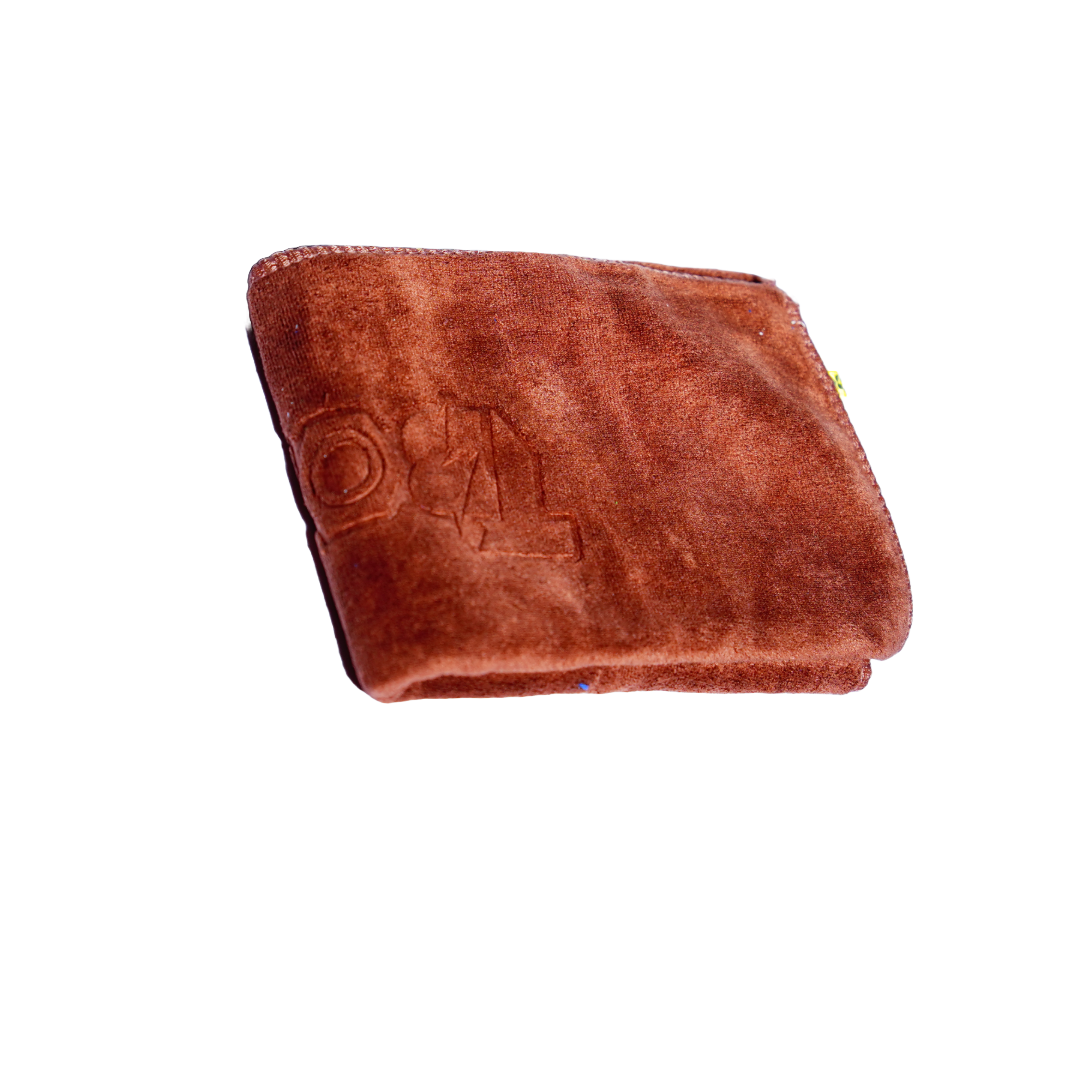A stack of microfiber cleaning cloths in blue, brown, red, and green colors.