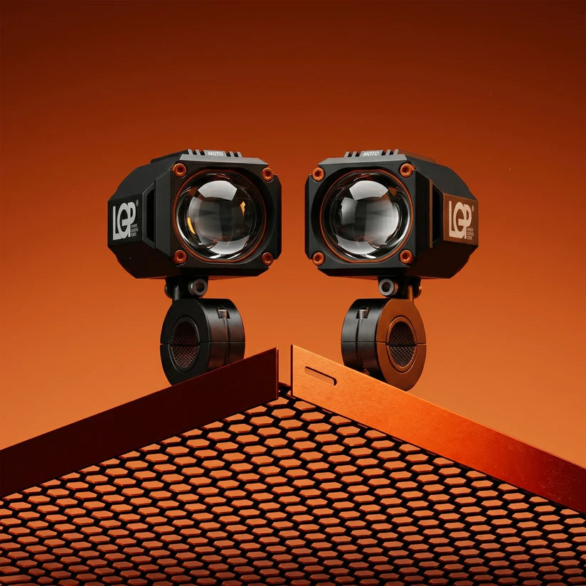 Two LED work lights on a textured surface with an orange gradient background